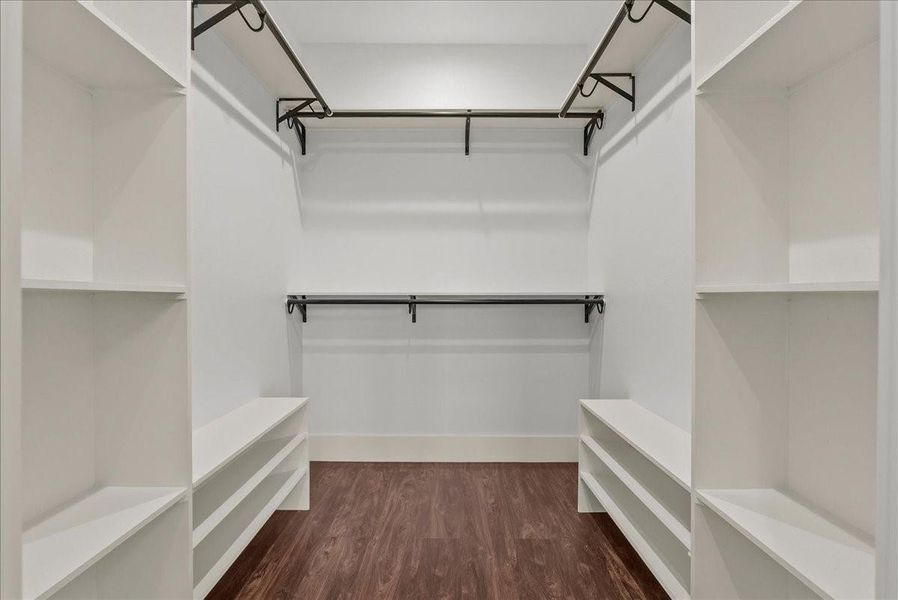 Expansive walk-in closet with custom built-in storage.