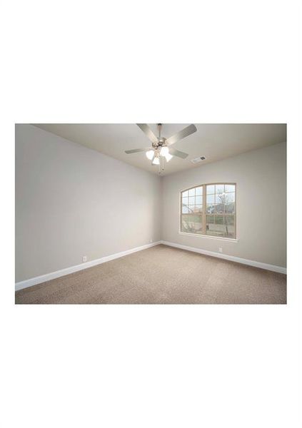 Carpeted empty room with ceiling fan