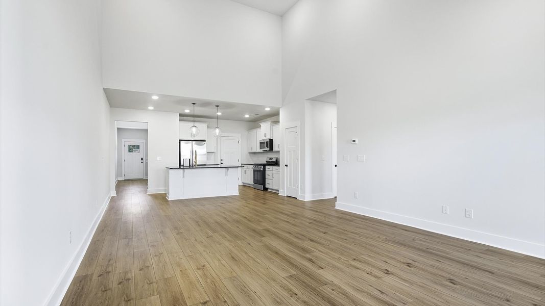 Vibrant family room with high-impact two-story ceilings and thoughtful layout for entertaining in Fountain Inn, SC