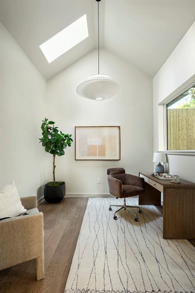 Office featuring lofted ceiling and a skylight