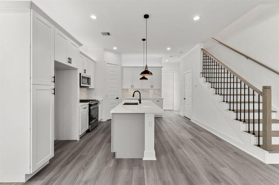 Here’s the view of the kitchen from the living area. It's a chef’s dream with plenty of cabinetry and spacious layout, making it perfect for entertaining!