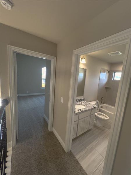 Full bathroom featuring vanity, toilet, a healthy amount of sunlight, and bathing tub / shower combination