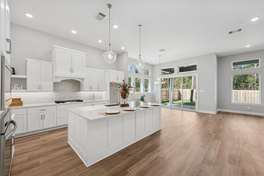 EXAMPLE PHOTO:  THIS home will have stacked cabinets with glass doors giving it a very elegant look!  Updraft vent hood, huge island/breakfast bar!