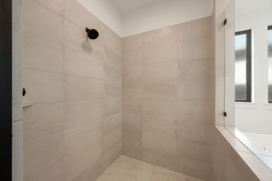 A well-appointed, naturally illuminated shower with textured tiling, perfect for daily refreshment. A well-appointed, naturally illuminated shower with textured tiling, perfect for daily refreshment.
