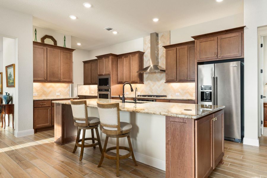 The kitchen features a large island with storage. The kitchen features a large island with storage.