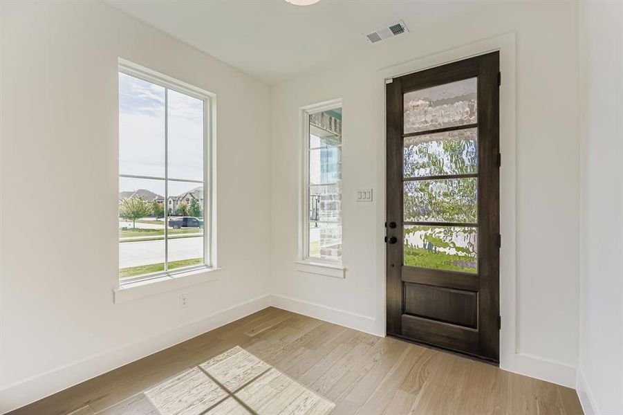 Foyer entrance with light wood-type flooring
