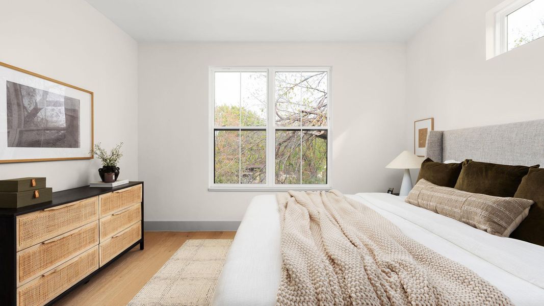 Bedroom featuring light wood-style floors and baseboards