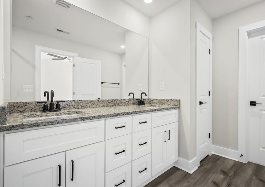 The primary bathroom includes double sink counters