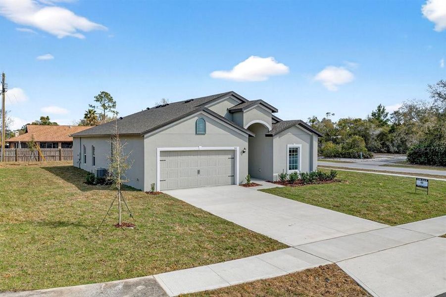 Front exterior of a new home in , Deltona, FL, highlighting curb appeal (Image 24).