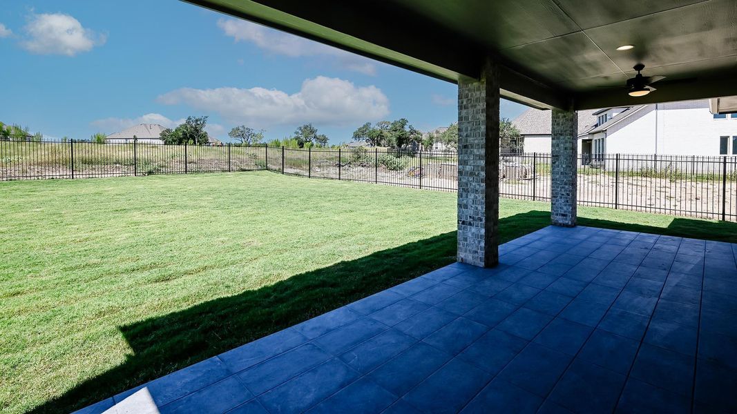 Fenced backyard featuring a patio area and ceiling fan Fenced backyard featuring a patio area and ceiling fan