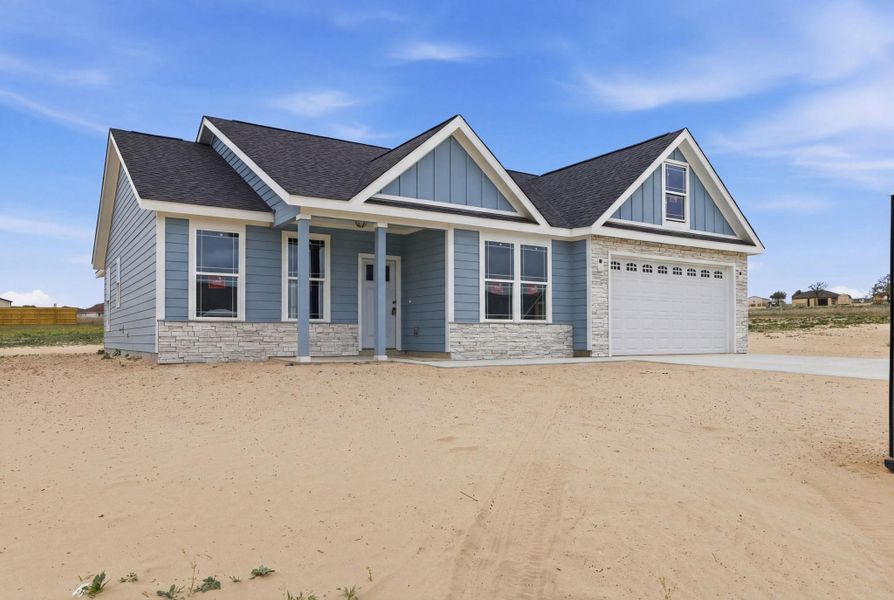 Front exterior of a new home in Las Palomas Country Club Estates, La Vernia, TX, highlighting curb appeal (Image 14).