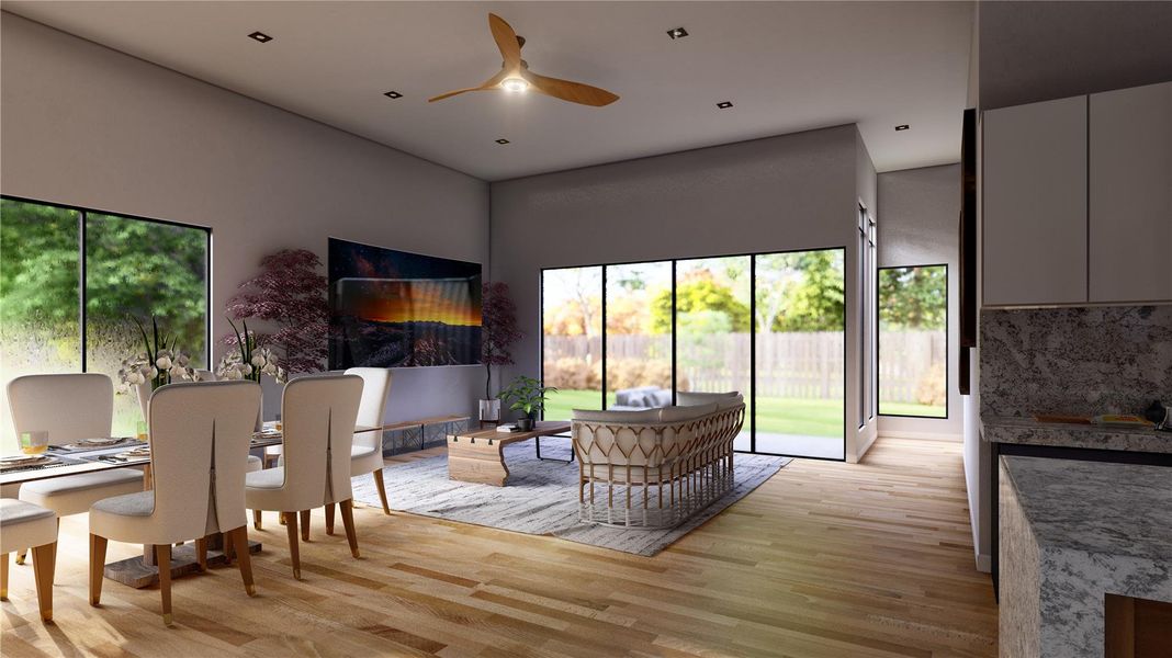 Dining room featuring light wood-style floors, plenty of natural light, and a ceiling fan