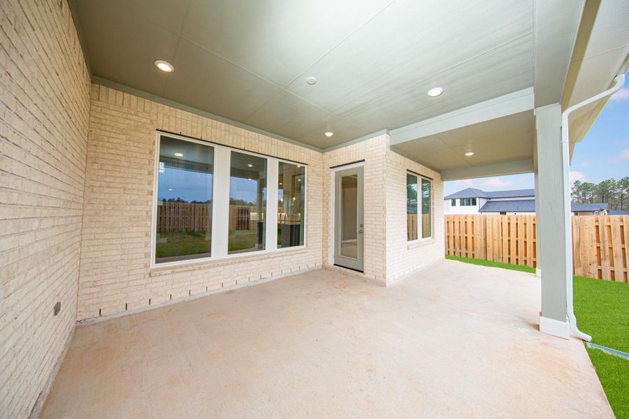 Step outside to the covered rear patio, the perfect extension of your indoor living space for year-round enjoyment.