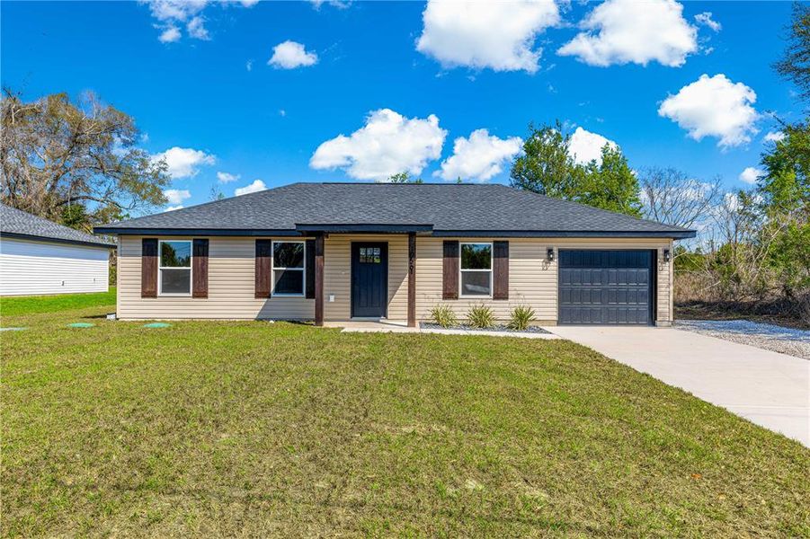 Front exterior of a new home in , Summerfield, FL, highlighting curb appeal (Image 1). Front exterior of a new home in , Summerfield, FL, highlighting curb appeal (Image 1).