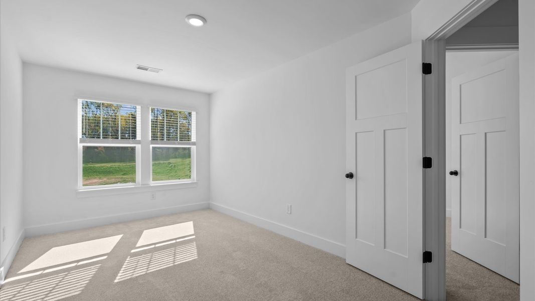 First-class bedroom with generous proportions, a walk-in closet, and beautiful natural light through large windows