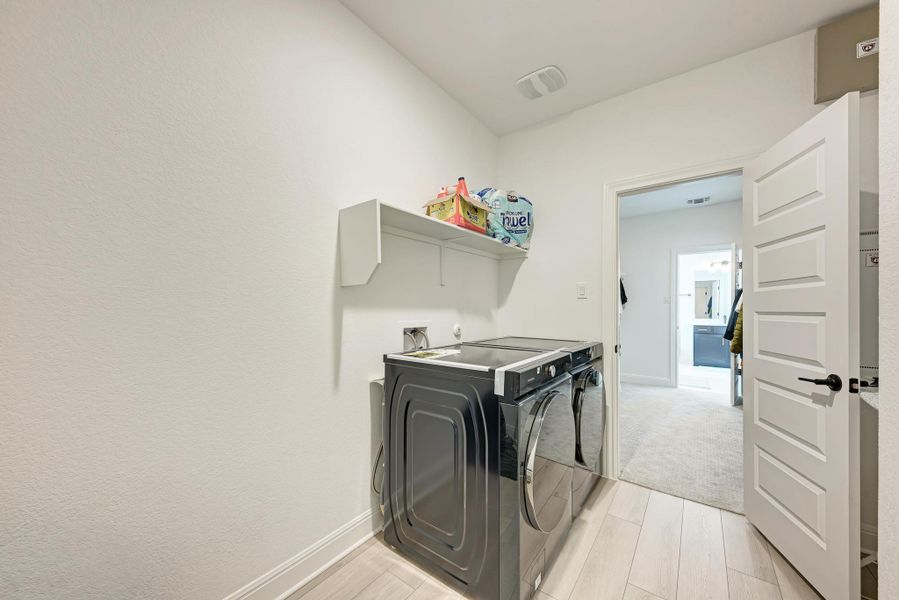 Laundry area featuring washing machine and clothes dryer and wood tiled floors