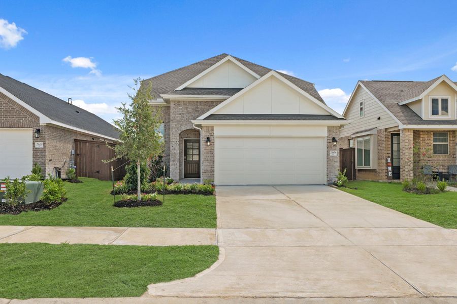 Front exterior of a new home in The Trails, New Caney, TX, highlighting curb appeal (Image 2).