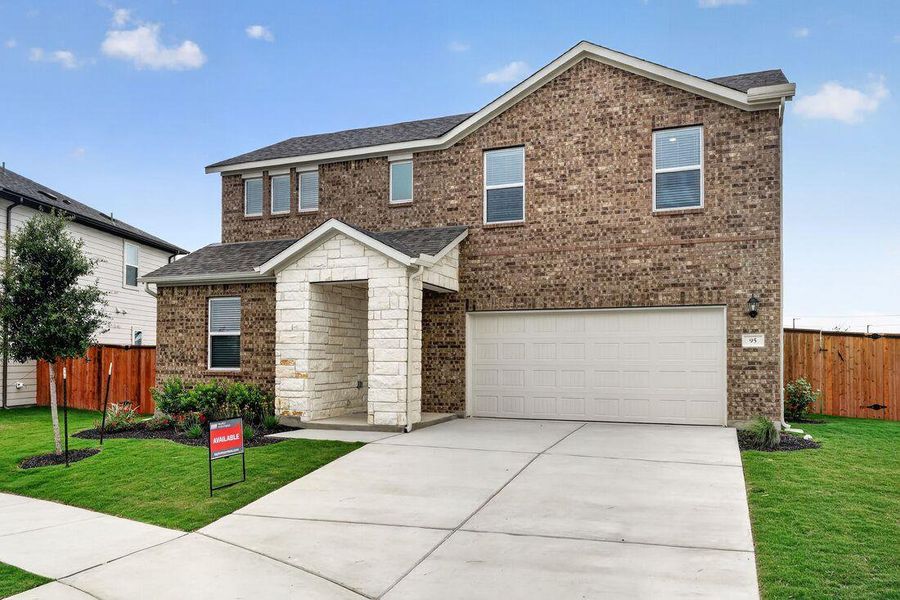 Front exterior of a new home in Emory Crossing, Hutto, TX, highlighting curb appeal (Image 2). Front exterior of a new home in Emory Crossing, Hutto, TX, highlighting curb appeal (Image 2).