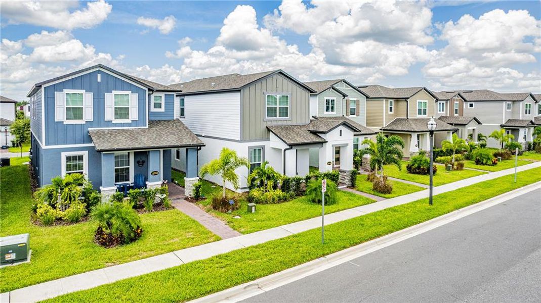 Front exterior of a new home in Encore at Ovation, Winter Garden, FL, highlighting curb appeal (Image 21).