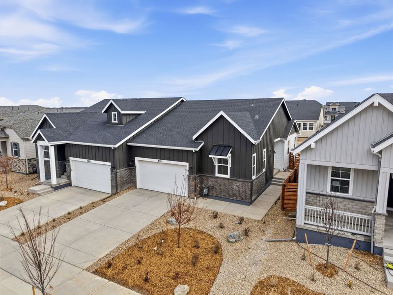 Front exterior of a new home in The Aurora Highlands, Aurora, CO, highlighting curb appeal (Image 15).