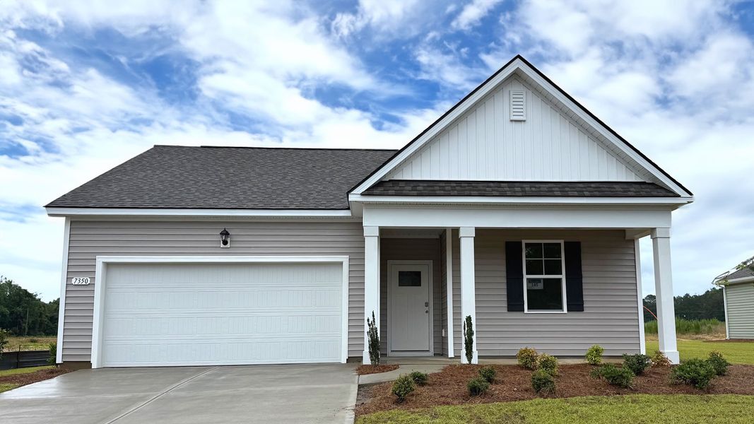 Front exterior of a new home in Meadow Walk, Loris, SC, highlighting curb appeal (Image 1).