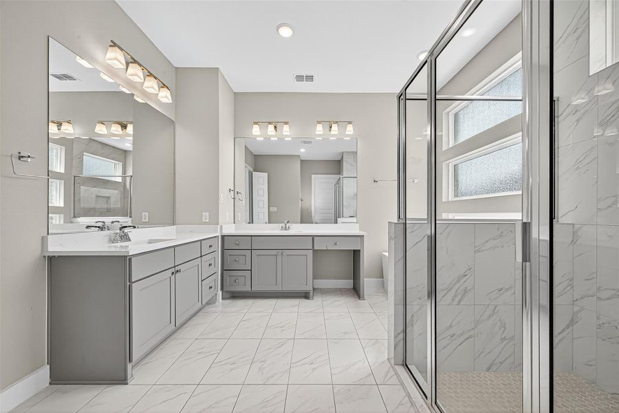 Primary bathroom features double sinks, separate shower, and separate tub.