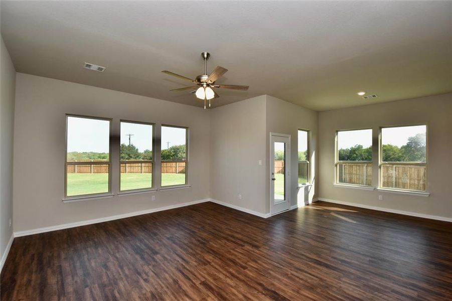 Unfurnished living room with dark wood finished floors, a ceiling fan, and recessed lighting