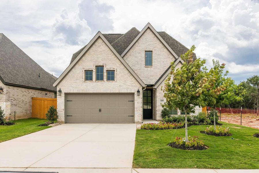 View of front of house with brick siding, concrete driveway, and a shingled roof View of front of house with brick siding, concrete driveway, and a shingled roof