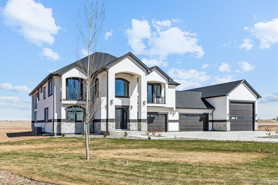 Front exterior of a new home in , Hudson, CO, highlighting curb appeal (Image 2).