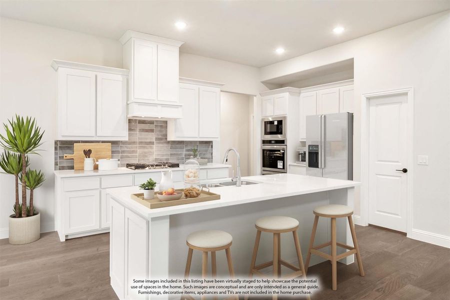 Kitchen with white cabinets, center island with seating, stainless steel appliances, and gray tile backsplash Kitchen with white cabinets, center island with seating, stainless steel appliances, and gray tile backsplash
