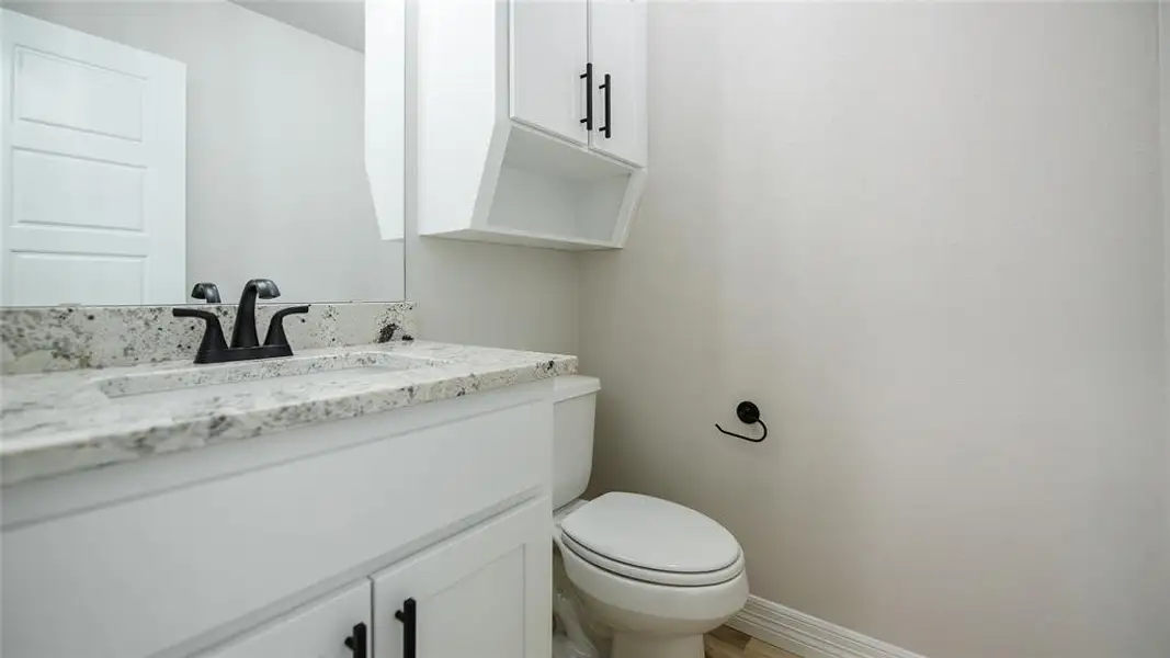 Bathroom with vanity and wood finished floors Bathroom with vanity and wood finished floors