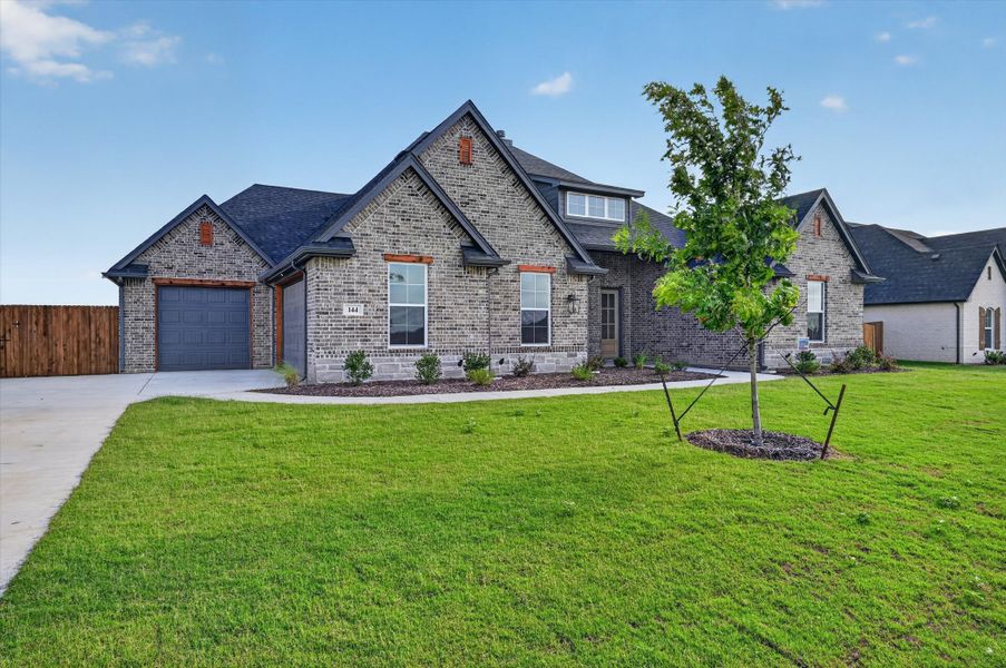 Front exterior of a new home in Coyote Crossing, Godley, TX, highlighting curb appeal (Image 1). Front exterior of a new home in Coyote Crossing, Godley, TX, highlighting curb appeal (Image 1).