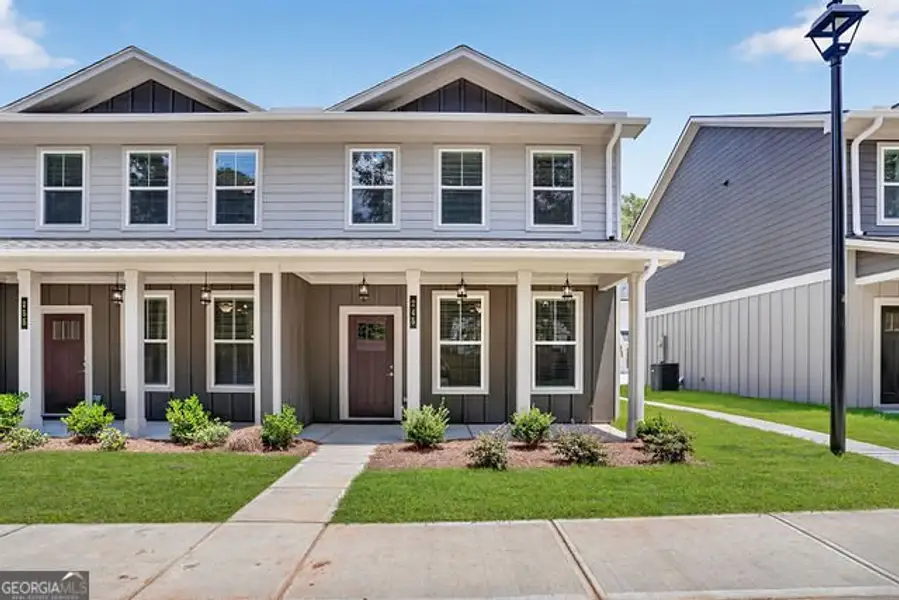 Front exterior of a new home in The Cottages at East Lanier, Fayetteville, GA, highlighting curb appeal (Image 1). Front exterior of a new home in The Cottages at East Lanier, Fayetteville, GA, highlighting curb appeal (Image 1).
