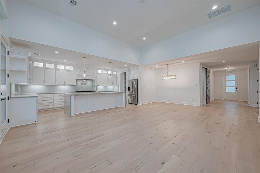 This spacious, open-concept living area with High ceilings and ample natural light