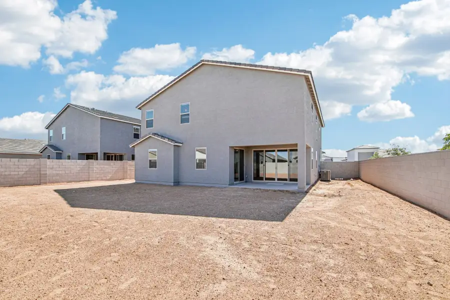 Back exterior elevation with covered patio. Finishes and options may vary by community