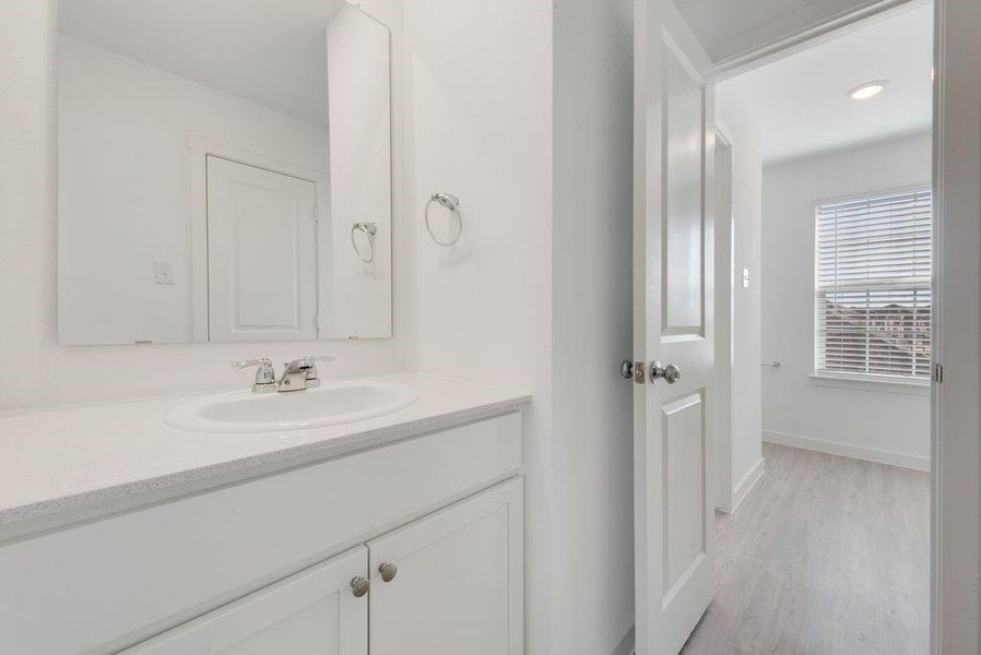 Bathroom featuring vanity, wood finished floors, and recessed lighting Bathroom featuring vanity, wood finished floors, and recessed lighting