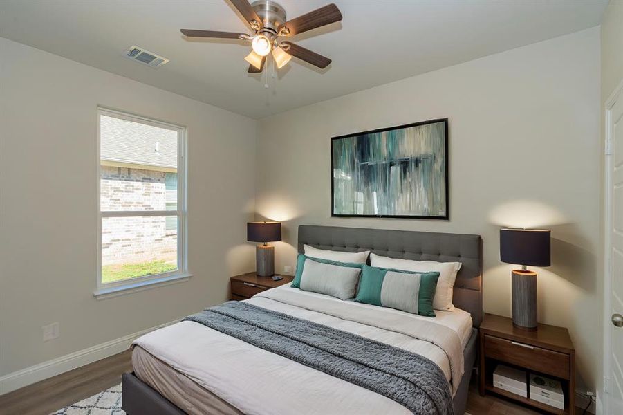 Bedroom with ceiling fan and dark hardwood / wood-style flooring