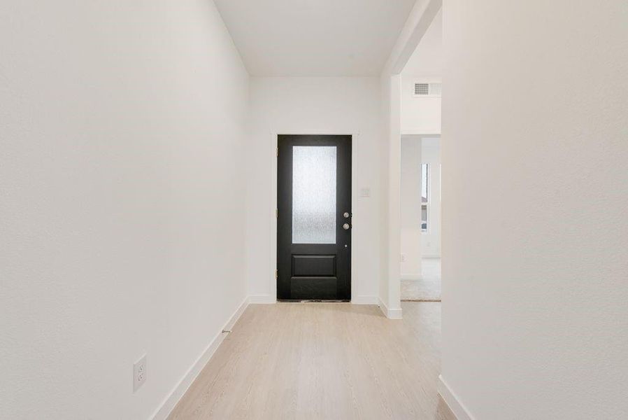 Doorway with wood finished floors and baseboards Doorway with wood finished floors and baseboards