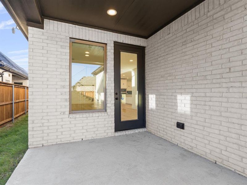 Doorway to property with a patio and brick siding Doorway to property with a patio and brick siding