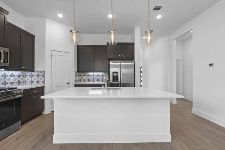 Representative furnished interior of a home built from the Adele by Chesmar Homes in Sunterra, Katy (Image 4).