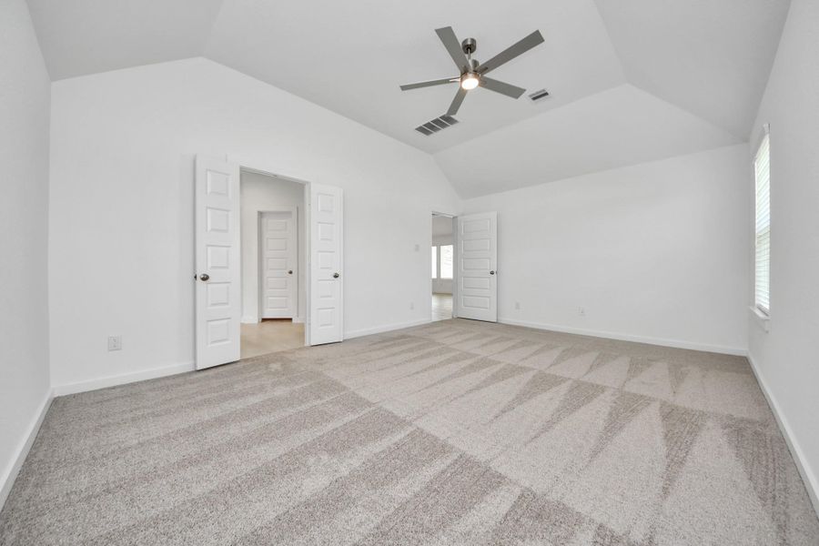 Come and unwind after a long day in this magnificent primary suite! This spacious room features plush carpet, warm paint, high ceilings and large windows with privacy blinds. Sample photo of completed home with similar floor plan. Actual colors and selections may vary.