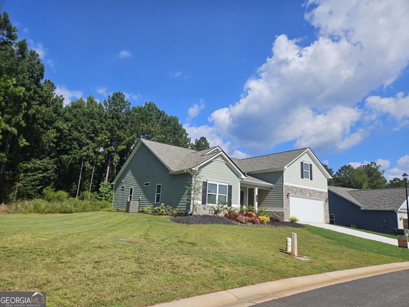 Front exterior of a new home in Maddox Station, Eatonton, GA, highlighting curb appeal (Image 23). Front exterior of a new home in Maddox Station, Eatonton, GA, highlighting curb appeal (Image 23).