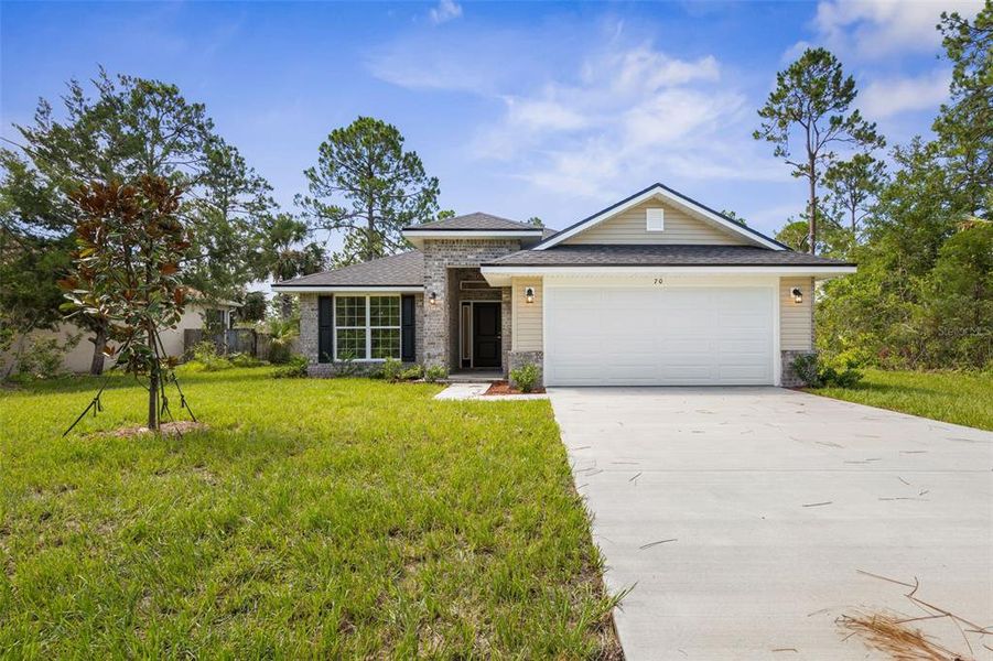 Front exterior of a new home in Palm Coast, Palm Coast, FL, highlighting curb appeal (Image 2).