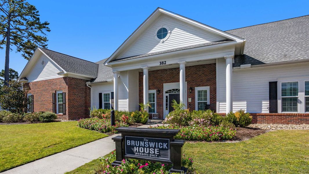 Front exterior of a new home in Brunswick Plantation, Ash, NC, highlighting curb appeal (Image 12). Front exterior of a new home in Brunswick Plantation, Ash, NC, highlighting curb appeal (Image 12).