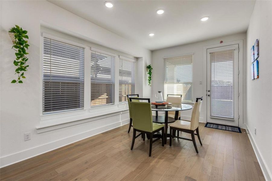 Dining room with light wood-type flooring, recessed lighting, and plenty of natural light Dining room with light wood-type flooring, recessed lighting, and plenty of natural light