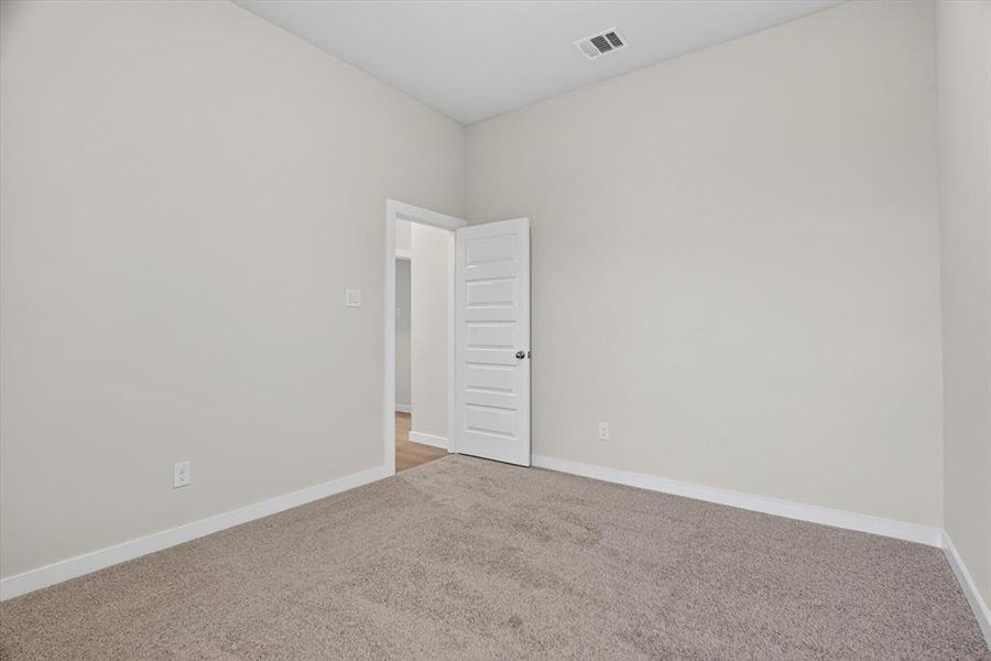 Neutral-toned carpeting paired with light walls and white trim