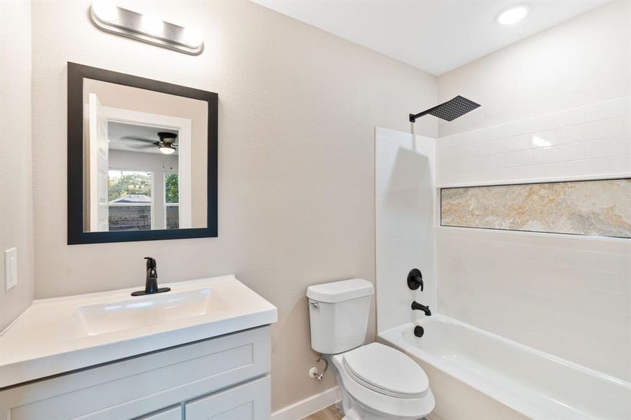 Full bath with washtub / shower combination and vanity