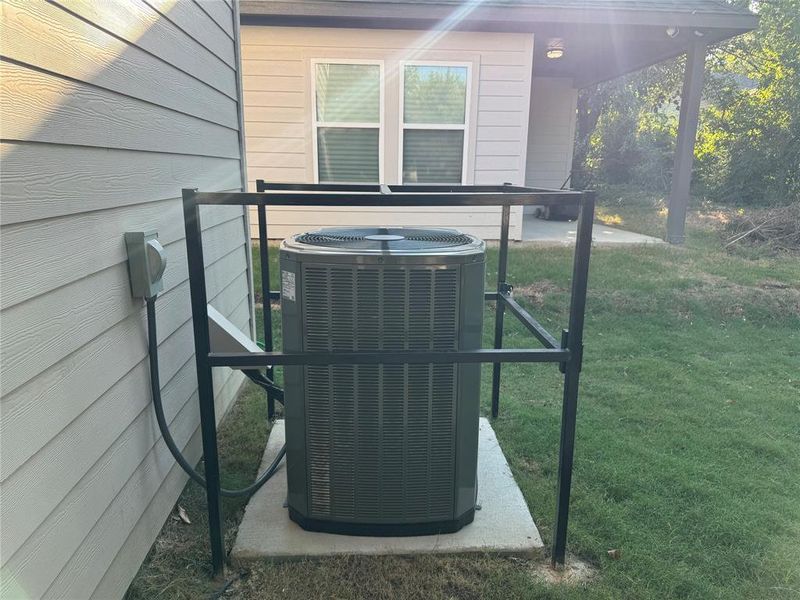 Exterior details featuring central AC and wooden walls