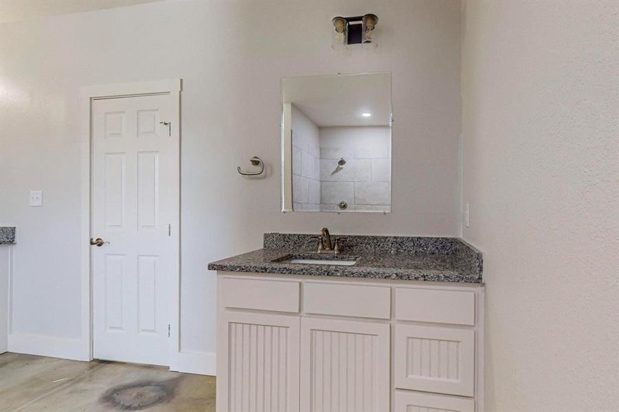 Bathroom with hardwood / wood-style flooring and vanity