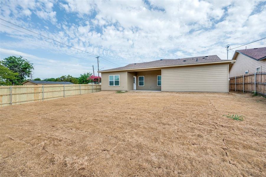 Rear view of property featuring a patio and a fenced backyard Rear view of property featuring a patio and a fenced backyard